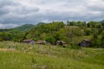 mountain_landscape_with_barns_by_12peaceart-da4lj31.jpg