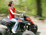 3110437-young-adult-female-riding-a-4-wheeler-on-a-dirt-road-with-good-panning-motion-blur-Stock.jpg